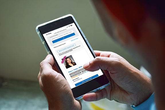 Someone scheduling doctor appointment on cell phone