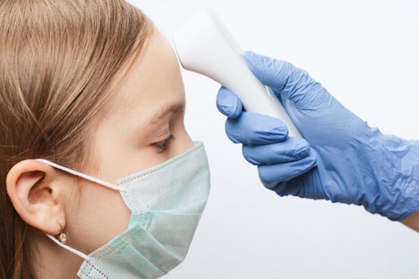 Provider taking temperature of child