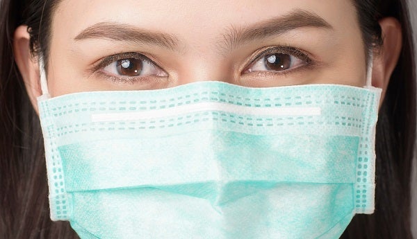 Woman smiling behind mask