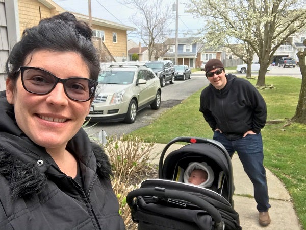 Dr. Brian Acunto and his wife Breanna take a walk observing social distance with their newborn daughter Annabelle