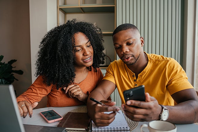 Couple Collaborating on Digital Tools at Home