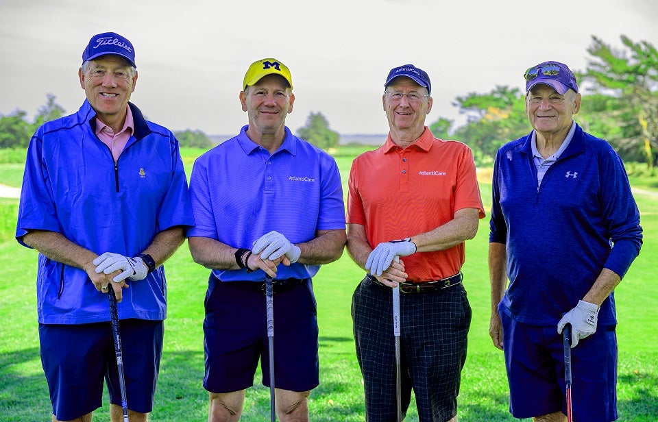 Golfers pose for photo 